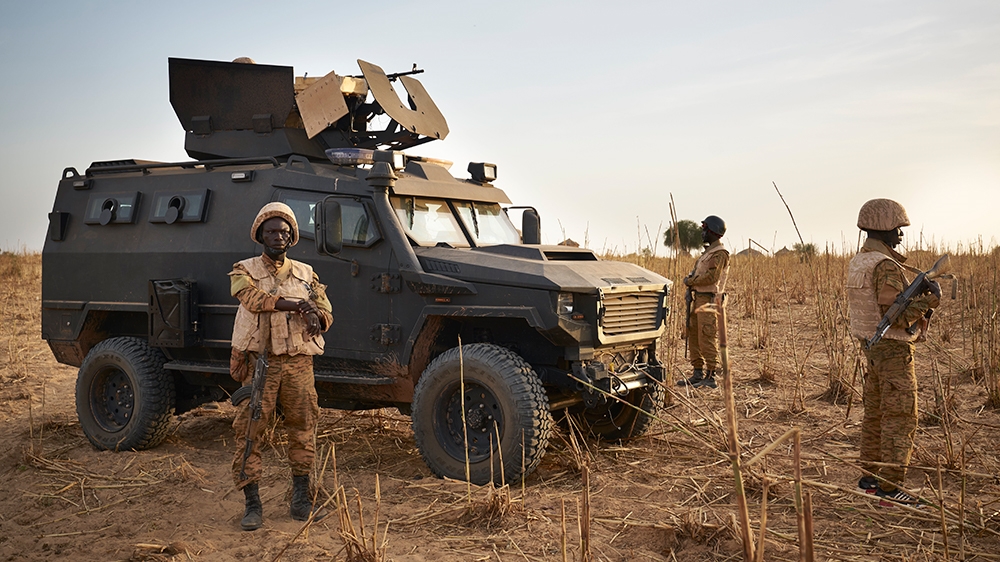 A group of soldiers from the Burkina Faso Army patrols a rural area during a joint operation with the French Army in the Soum region along the border with Mali on November 9, 2019. (Photo by MICHELE C