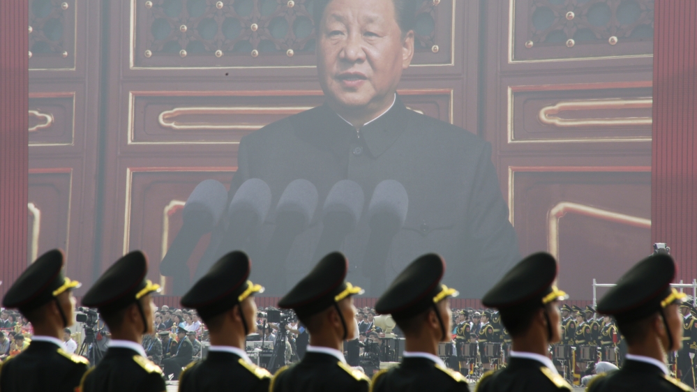 Soldiers of People''s Liberation Army (PLA) are seen before a giant screen as Chinese President Xi Jinping speaks at the military parade