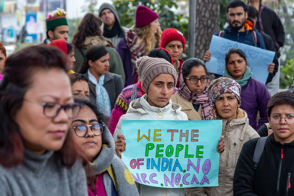 A woman holds a banner as she participates in a gathering protesting the Citizenship Amendment Act and the National Register of Citizens in Dharmsala, India, Thursday, Dec. 19, 2019. Police detained s