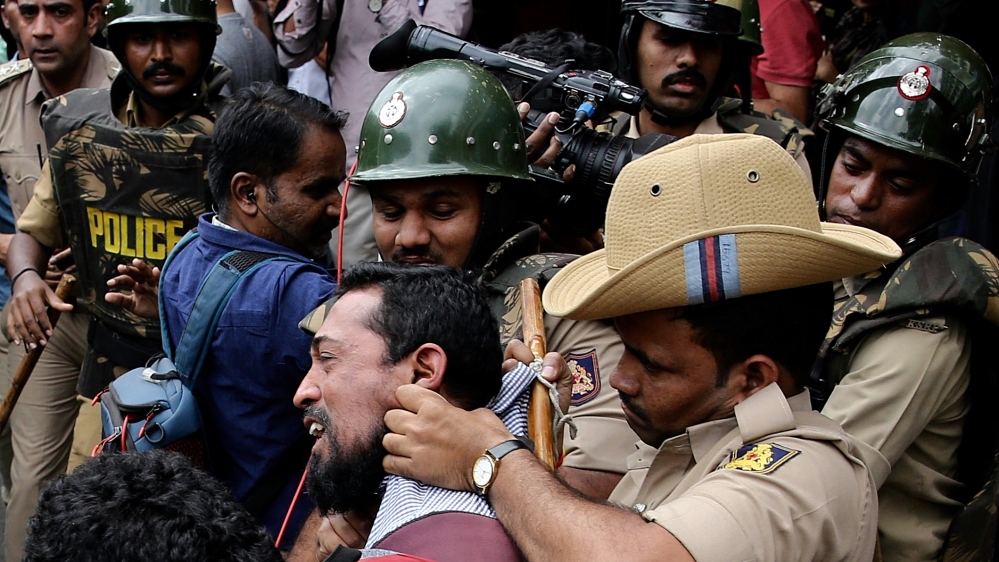 Indian policemen detain protesters during a protest in solidarity with Jamia Millia Islamia University students and against the Citizenship Amendment Bill (CAB) and National Register of Citizens (NRC)