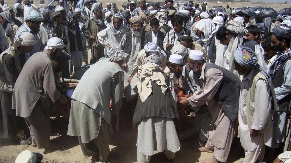 In this photograph taken on September 4, 2009, Afghan mourners prepare to bury victims during a funeral in Kunduz, after an ISAF airstrike on an oil tanker hijacked by Taliban insurgents. More than 10