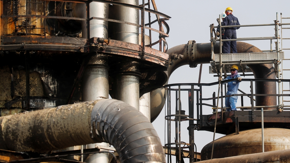 Employees work at the damaged site of Saudi Aramco oil facility in Abqaiq