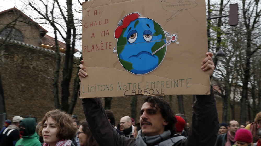 Protestors holding a cardboard reading "I am hot for my planet, limit the carbon print" take part of a climate change protest march calling for the U.N. COP 25 climate talks in Madrid, to address clim