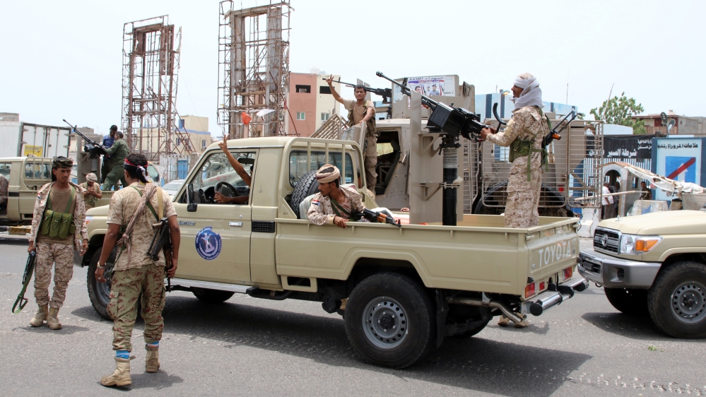 Members of UAE-backed southern Yemeni separatist forces patrol a road during clashes with government forces in Aden, Yemen