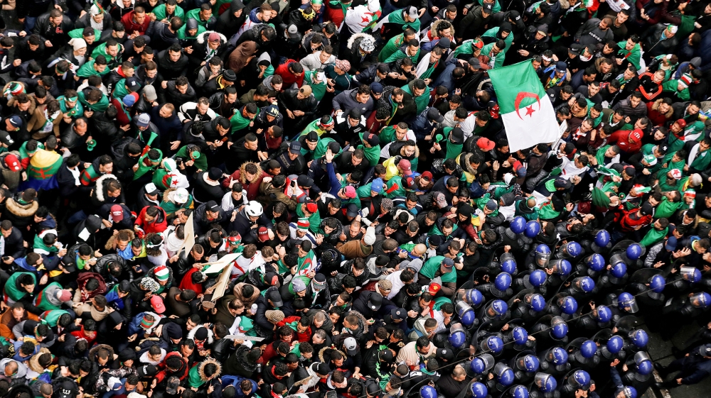Police officers attempt to disperse demonstrators trying to force their way to the presidential palace during a protest calling on President Abdelaziz Bouteflika to quit, in Algiers, Algeria March 22,