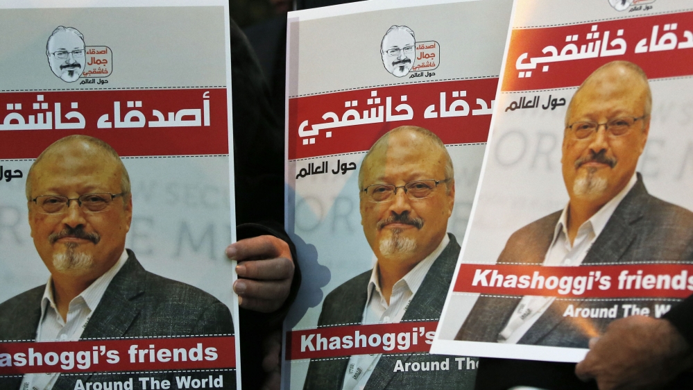 Activists protesting the killing of Saudi journalist Jamal Khashoggi hold a candlelight vigil outside Saudi Arabia's consulate in Istanbul, Thursday, Oct. 25, 2018. The posters read in Arabic:' Khas