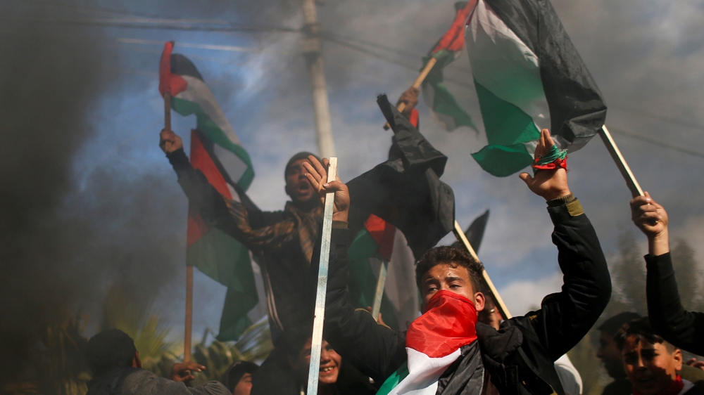 Palestinians protest as smoke rises from burning tires ahead of the announcement by U.S. President Donald Trump of his long-delayed Mideast peace plan, in Gaza City January 28, 2020. 