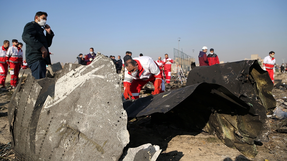 TEHRAN, IRAN - JANUARY 08: Officials inspect pieces of the plane at site after a Boeing 737 plane belonging to a Ukrainian International Airlines crashed near Imam Khomeini Airport in Iran just after 