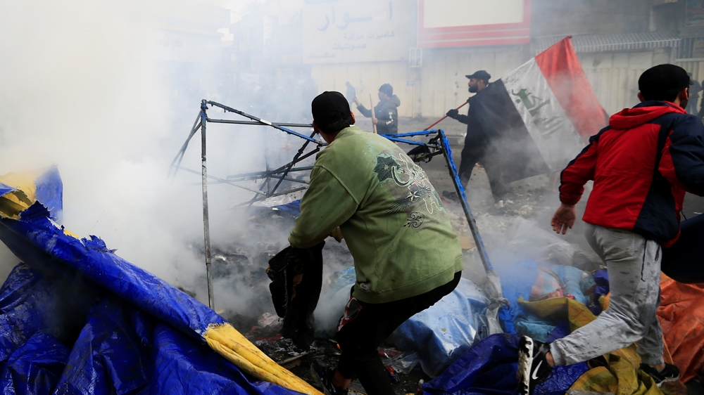 Smoke rises from burning tents as Iraqi security forces raid at Tahrir Square during ongoing anti-government protests in Baghdad, Iraq January 25, 2020. REUTERS/Thaier al-Sudani
