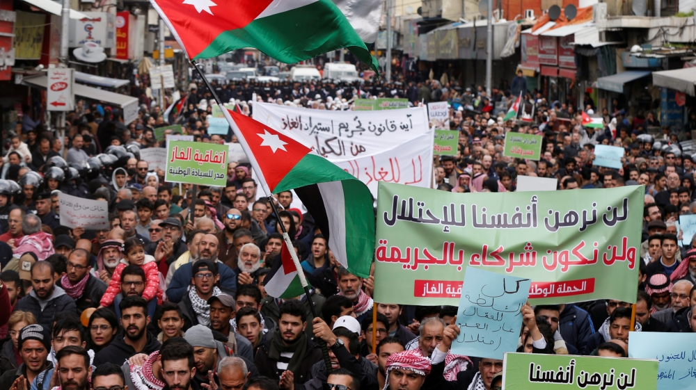 Demonstrators hold Jordanian national flags and chant slogans during a protest against a government''s agreement to import natural gas from Israel, in Amman