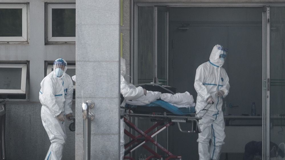 Medical staff carry a patient into the Jinyintan hospital, where patients infected with a new strain of Coronavirus identified as the cause of the Wuhan pneumonia outbreak are being treated, in Wuhan,
