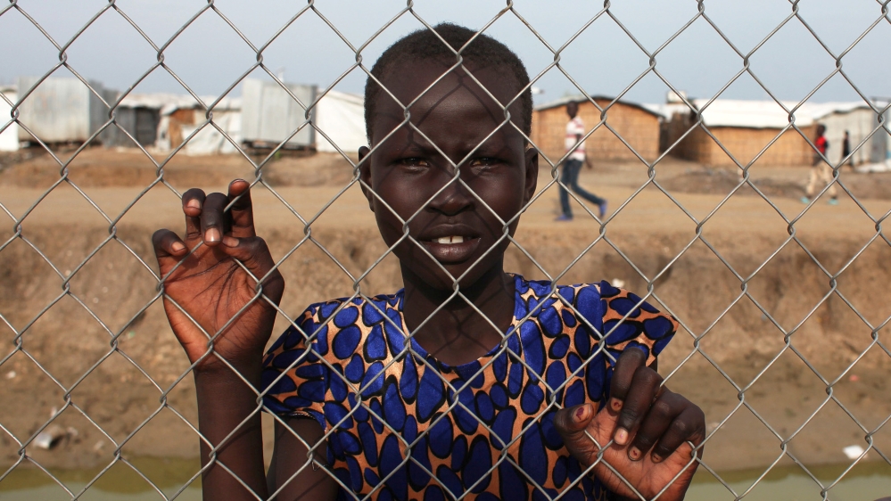 An internally displaced girl poses for a photo in the Protection of Civilians site in the UN base in Bentiu