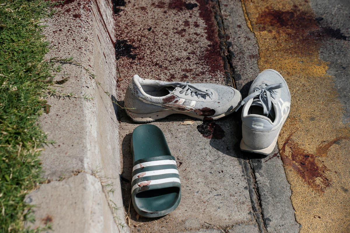 SENSITIVE MATERIAL. THIS IMAGE MAY OFFEND OR DISTURB Shoes belonging to victims and blood stains are seen in front of the Terminal 21 shopping mall following a gun battle involving a Thai soldi