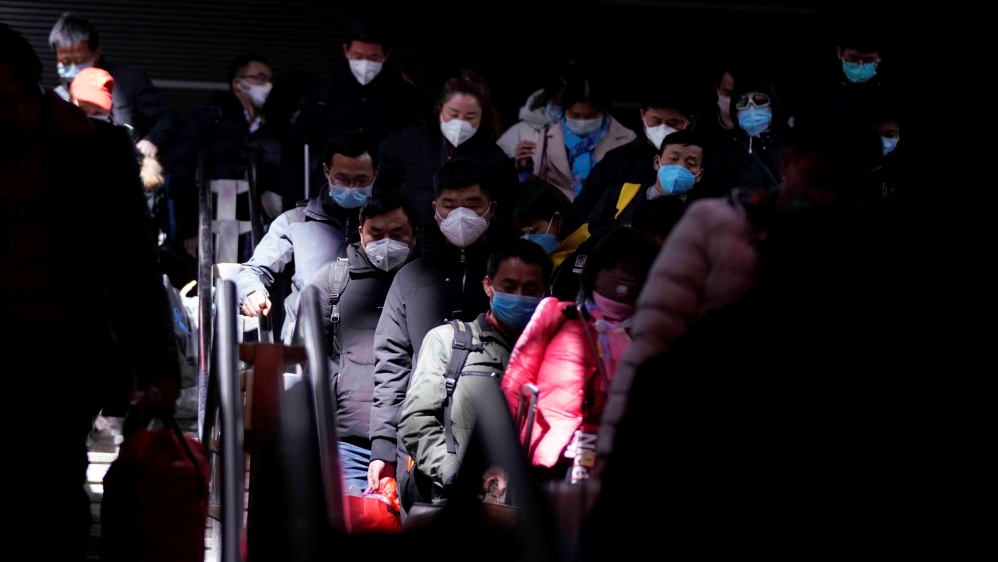 Passengers wearing masks are seen arrival at the Shanghai railway station in Shanghai