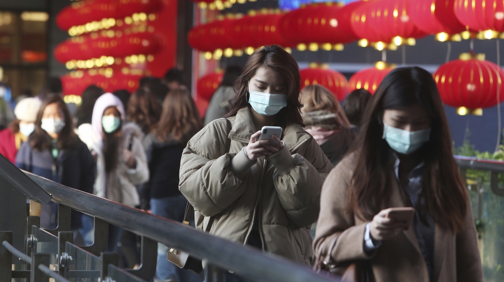 People wear face masks as they walk through a shopping mall in Taipei, Taiwan [Chiang Ying-ying/AP Photo]