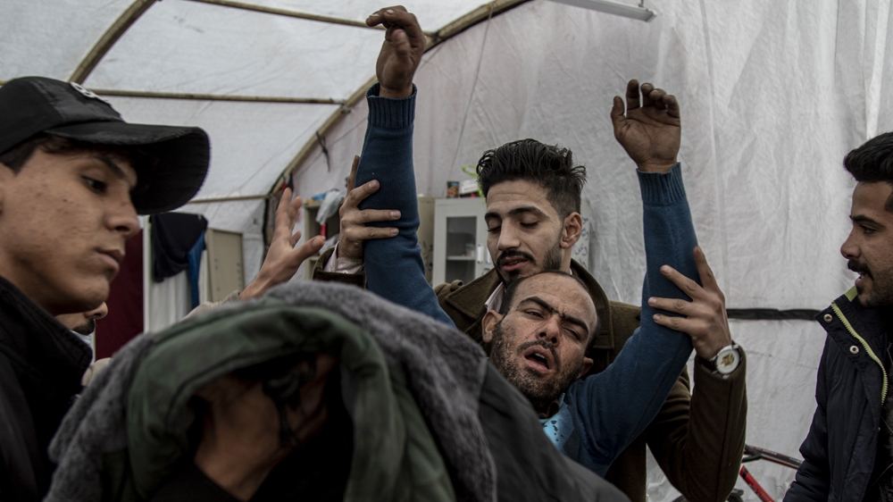 A protester suffers from tear gas inhalation at Baghdad's Tahrir Square