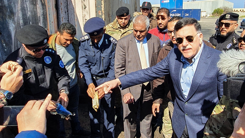 Prime Minister of Libya''s UN-recognised Government of National Accord (GNA) Fayez al-Sarraj, flanked by journalists, visits the port in the capital Tripoli after it was hit by rocket fire on February