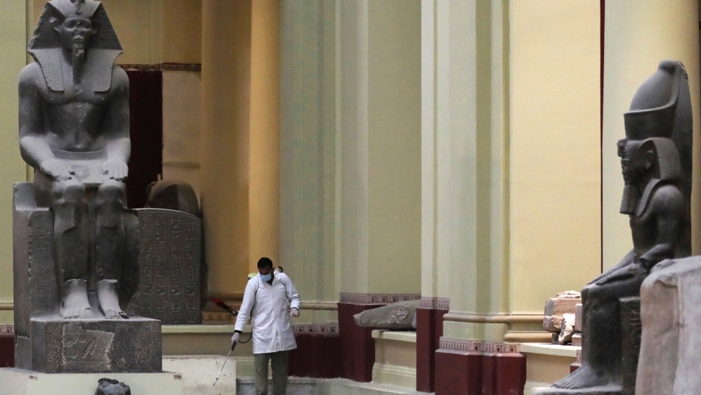 A member of a medical team sprays disinfectant inside the Egyptian Museum in Cairo