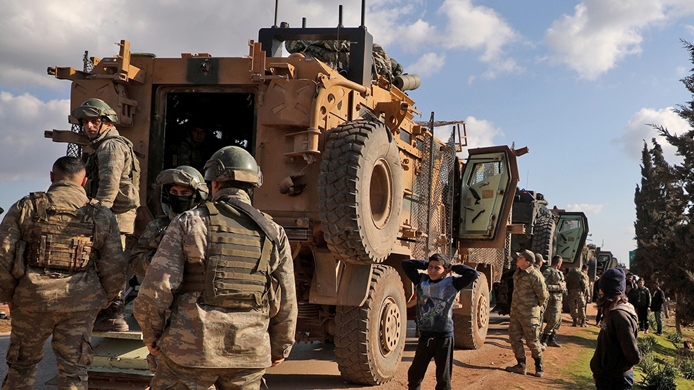 A Turkish military convoy is seen parked near the town of Batabu on the highway linking Idlib to the Syrian Bab al-Hawa border crossing with Turkey, on March 2, 2020. - The Syrian government pledged t
