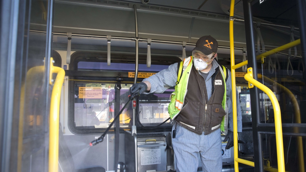 Larry Bowles, an equipment service worker for King County Metro, sprays Virex II 256, a disinfectant, throughout a metro bus at the King County Metro Atlantic/Central operating base on March 4, 2020, in Seattle, Washington
