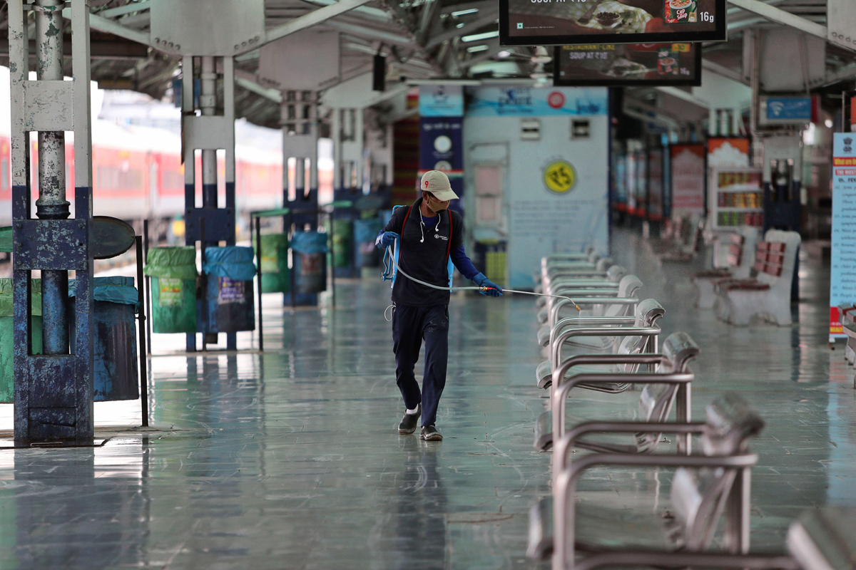 An Indian railway worker sprays disinfectants as a precautionary measure against COVID-19 in Jammu, India, Tuesday, March 24, 2020. Authorities have gradually started to shutdown much of the country o