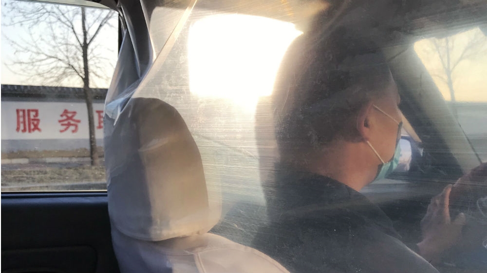 Some taxi drivers have surrounded themselves with plastic sheeting as protection against the coronavirus