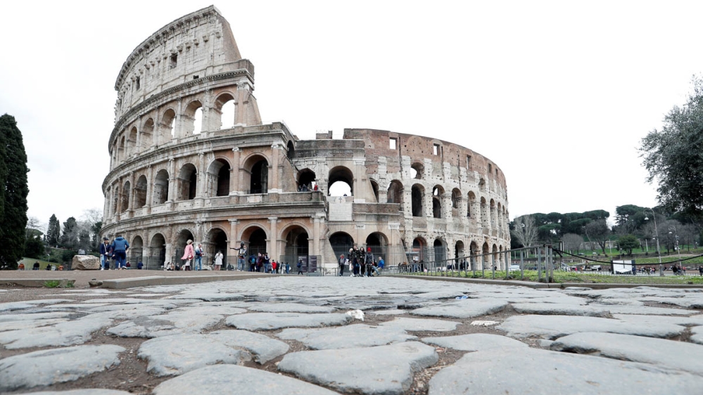 Very few people are seen in the area surrounding the Colosseum, which would usually be full of tourists, in Rome, Italy, March 2, 2020. Italy's tourism industry has been affected by a coronavirus outb