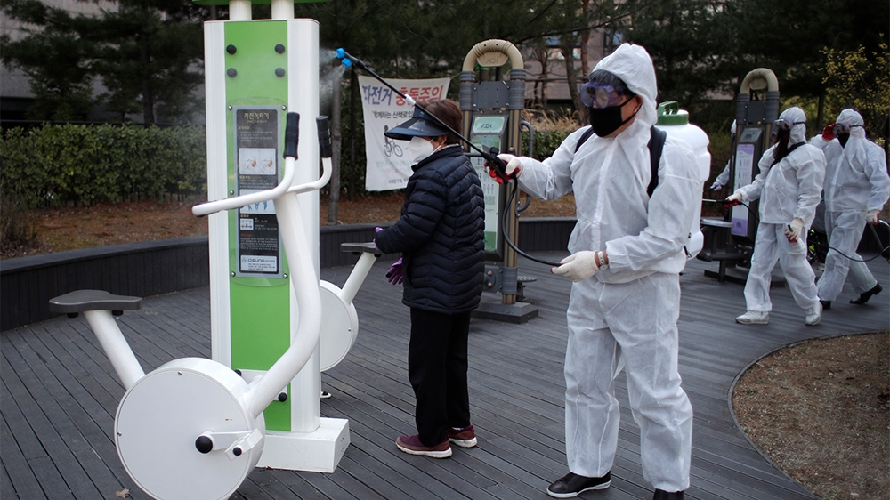 Residents of Bukgajwa1dong, wearing protective gears disinfect as a precaution against the new coronavirus at a park in Seoul, South Korea, Monday, March 23, 2020. For most people, the new coronavirus