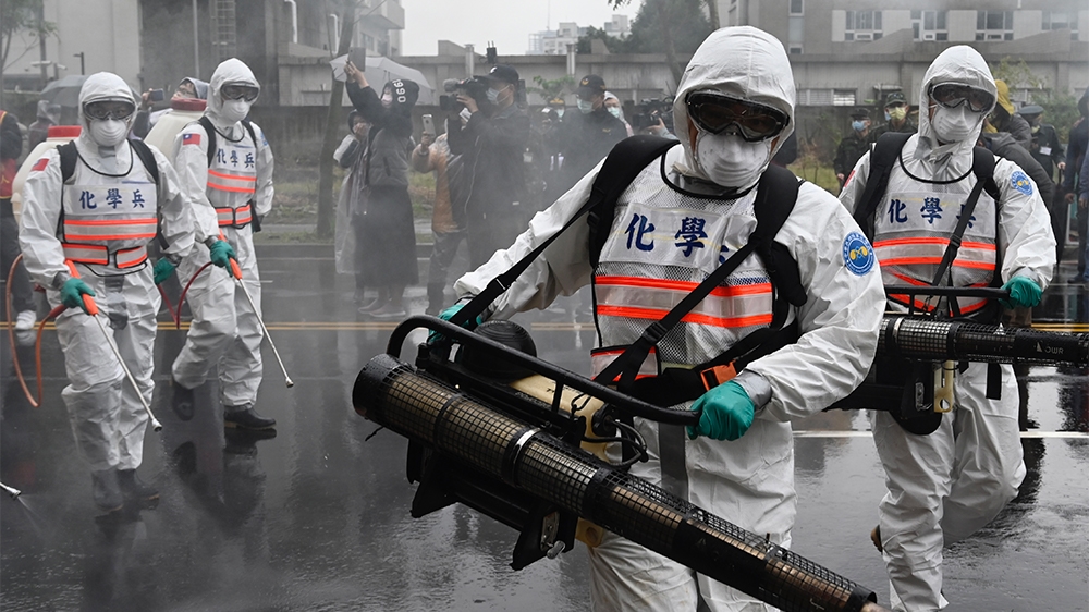 Soldiers from the militaryi´s chemical units take part in a drill organised by the New Taipei City government to prevent the spread of the COVID-19 coronavirus, in Xindian district on March 14, 2020.