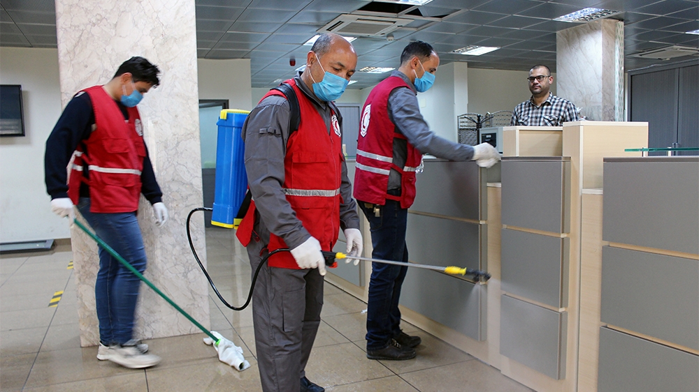 Members of Red Crescent spray disinfectants, as part of precautionary measures against coronavirus disease (COVID-19) at government offices in Misrata, Libya March 21, 2020. Picture taken March 21, 20