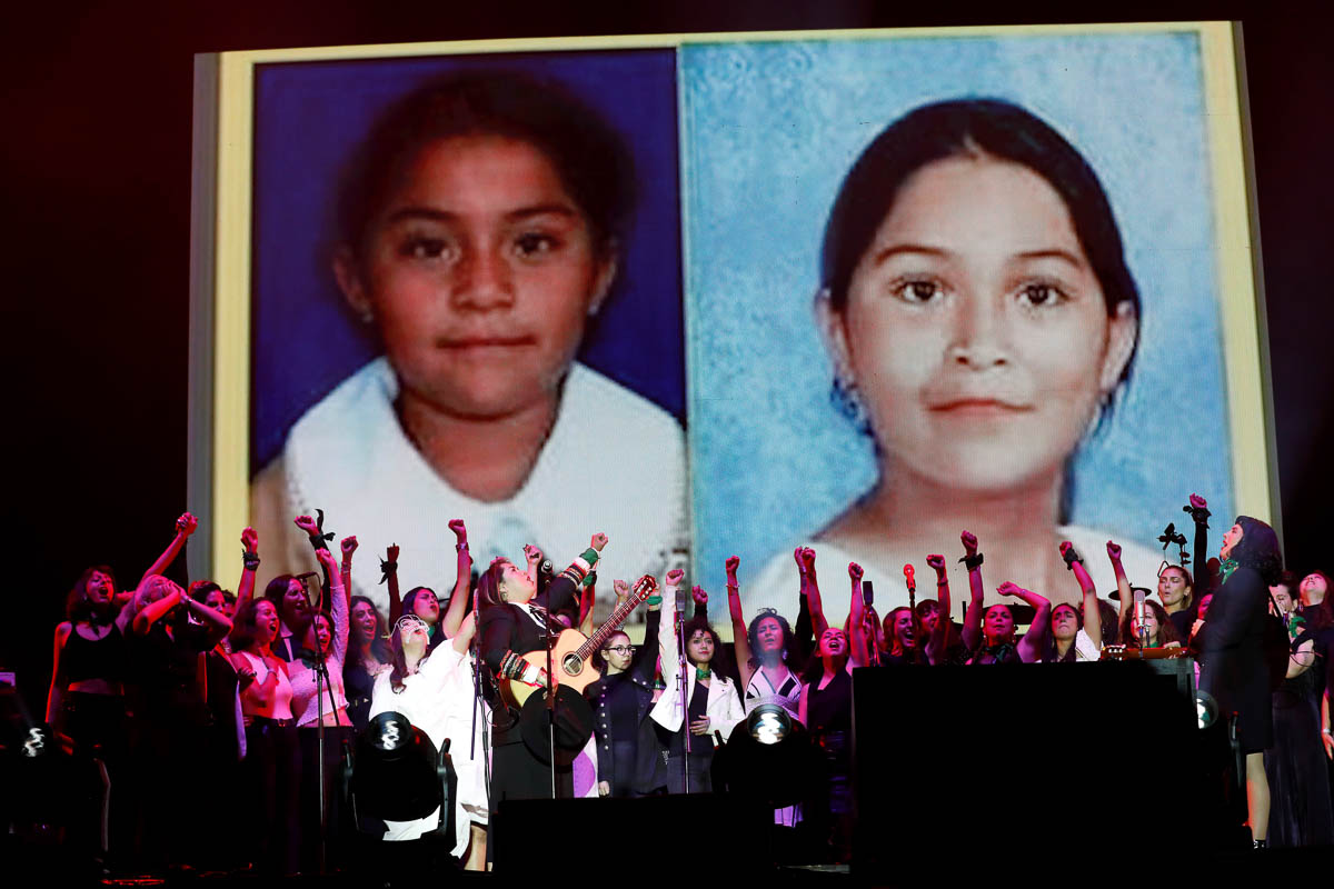 Songwriter Vivir Quintana (L) and Chilean singer Mon Laferte perform with members of the female collective of Latin-American singers and authors ''El Palomar'', as they sing "Song Without Fear.", a song