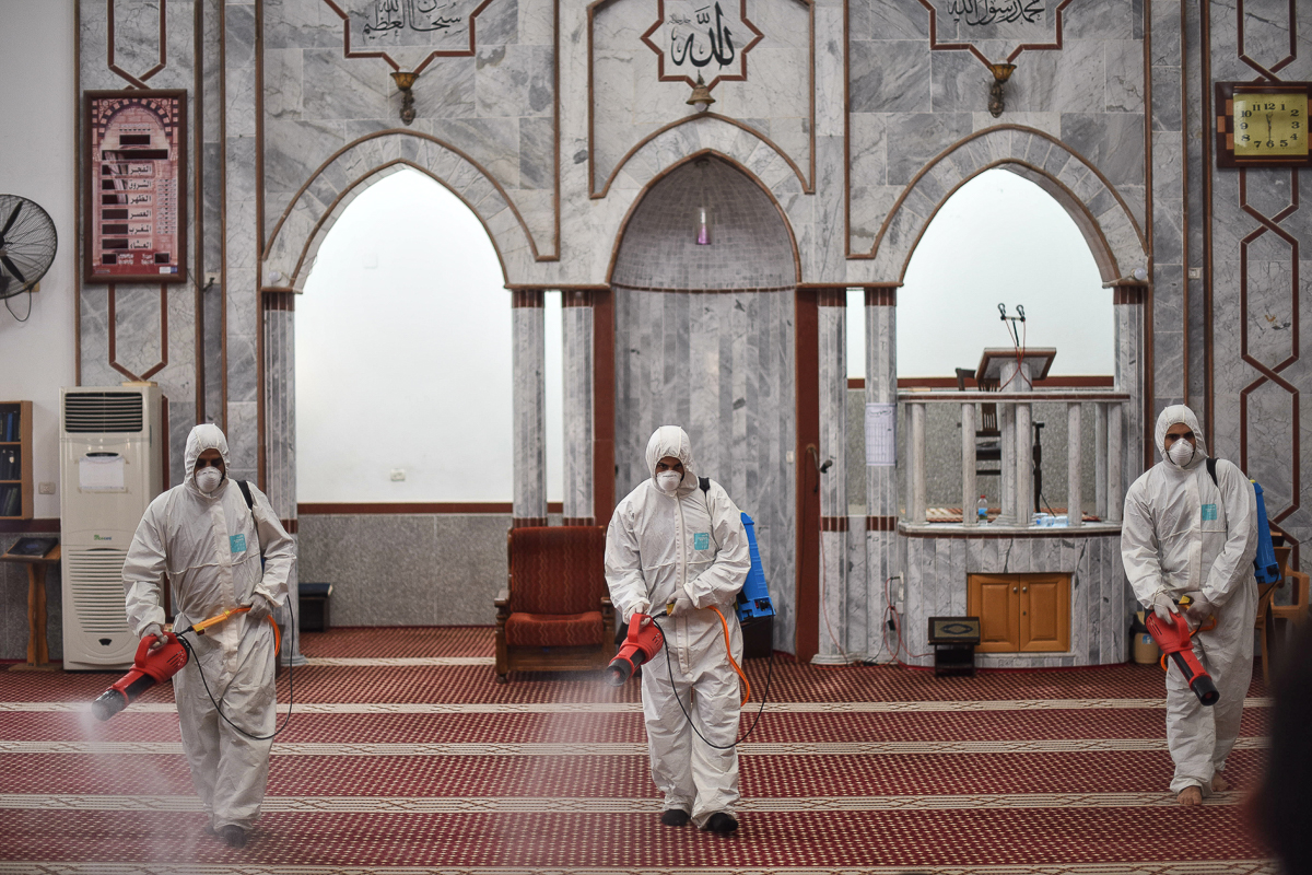 Volunteers disinfect al-Islam mosque in Khan Yunis, southern Gaza Strip. Mosques, educational institutions and markets are currently closed as a precaution.