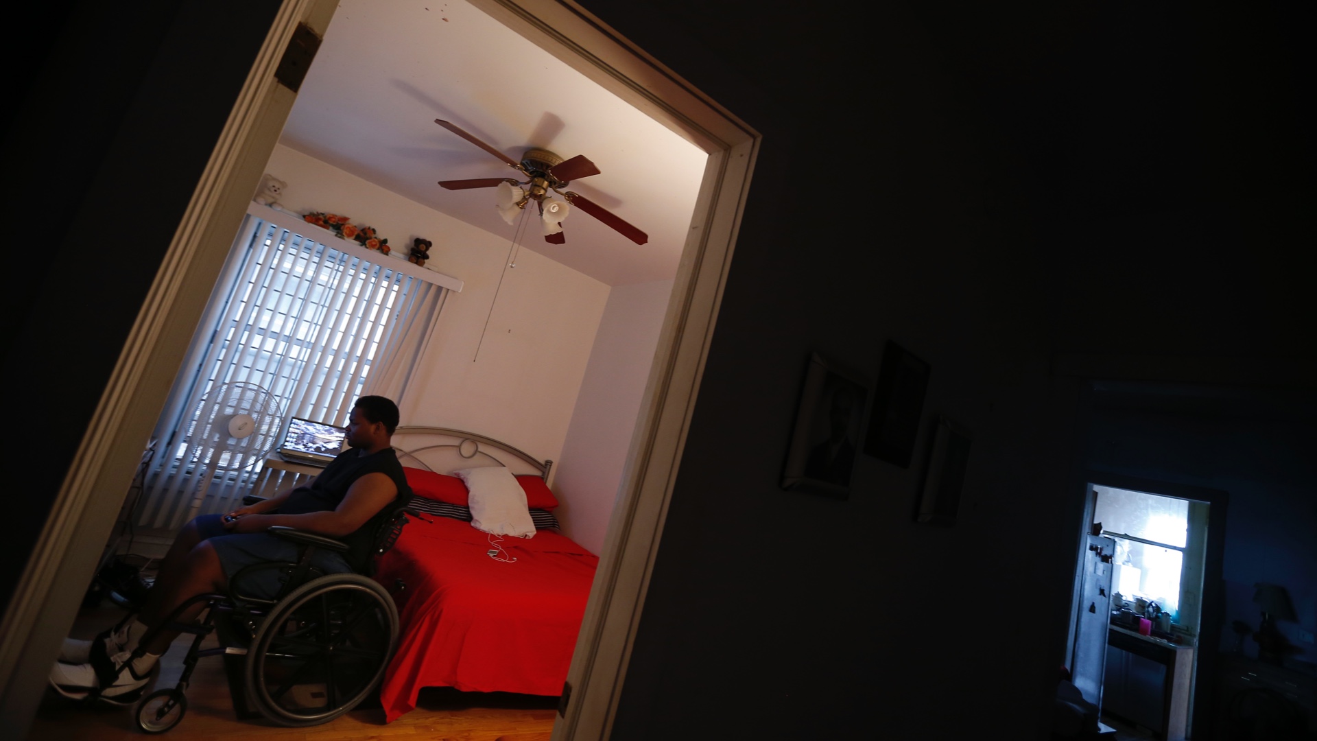 A man sits in his wheelchair in his home in Chicago, Illinois