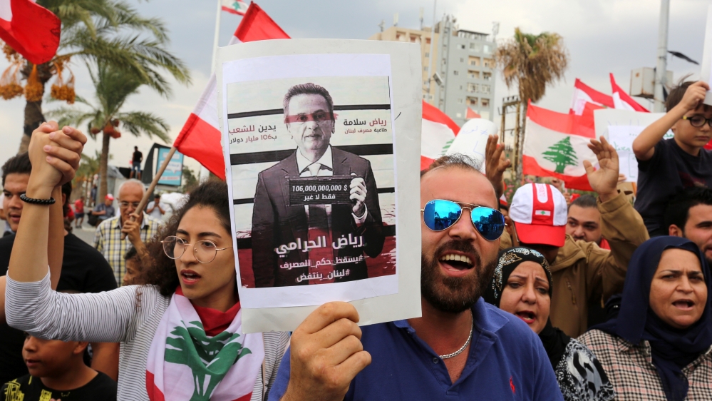 Demonstrators carry Lebanese flag