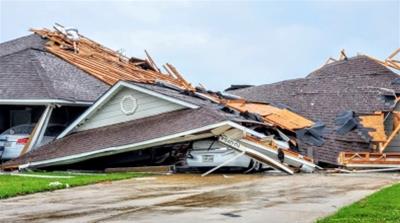 Damaged buildings and vehicles are seen in the aftermath of a tornado in Monroe, Louisiana, U.S. April 12, 2020, in this still image obtained from social media. Courtesy of Peter Tuberville/Social Med