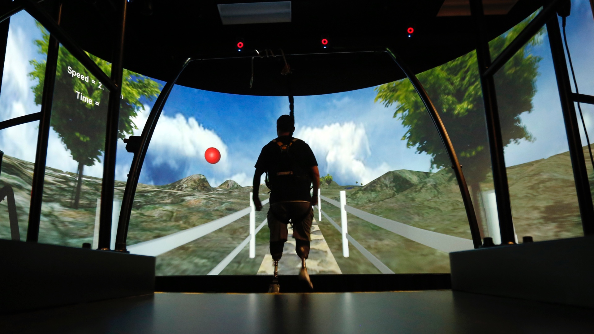 A wounded soldier with prosthetic legs uses a treadmill in Bethesda, Maryland