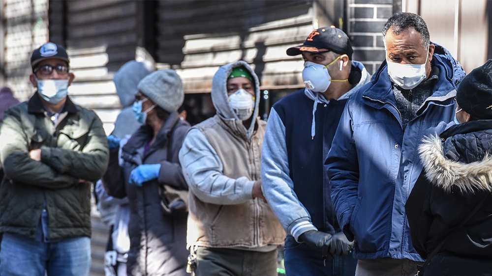 NEW YORK, NY - APRIL 1: People stand in line while wearing face masks in the Elmhurst neighborhood on April 1, 2020 in New York City. With more than 75,000 confirmed cases of COVID-19 and more than 1,