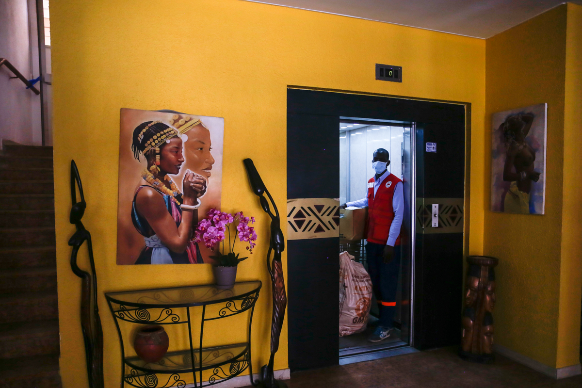 A Red Cross volunteer in light protective gear prepares to bring food and care to suspect cases quarantined in a central Dakar hotel. ‘’The hardest part is seeing families split up and forced to stay
