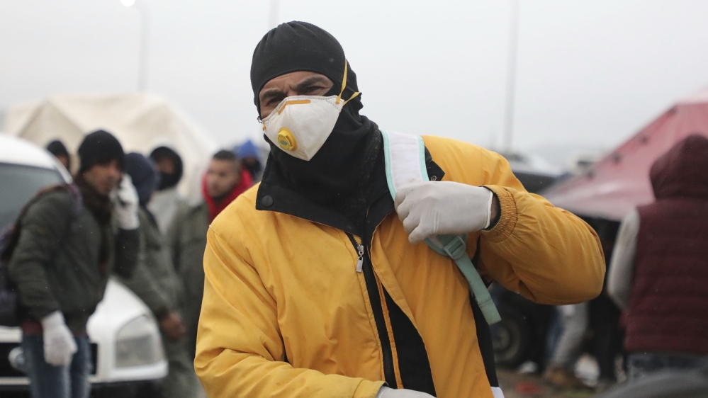 Palestinian labourers enter Israel to work through a checkpoint between the West Bank city of Hebron and Beersheva while carrying blankets and mattresses on March 18, 2020 as for the first time they h