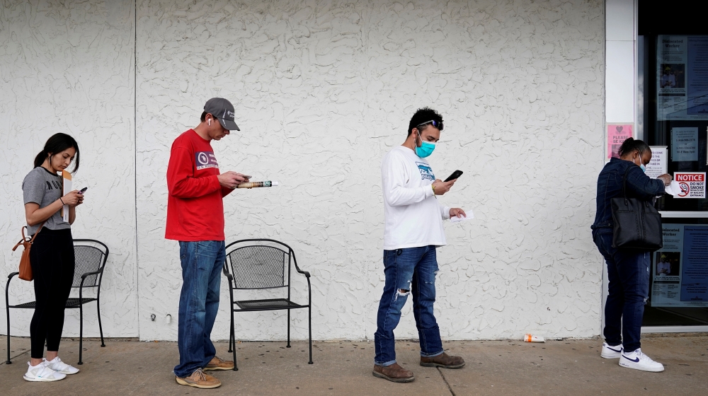 People who lost their jobs wait in line to file for unemployment following an outbreak of the coronavirus disease (COVID-19), at an Arkansas Workforce Center in Fayetteville, Arkansas, U.S. April 6, 2