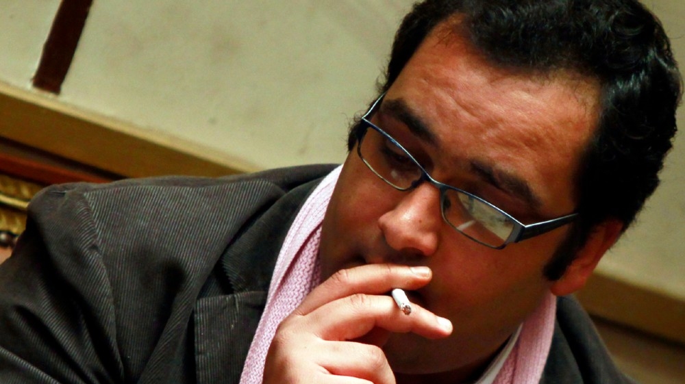 Ziad al-Elaimy Member of Parliament (MP) from the Egyptian Social Democratic Party, smokes a cigarette before a parliament session in Cairo February 26, 2012. Ziad al-Elaimy was