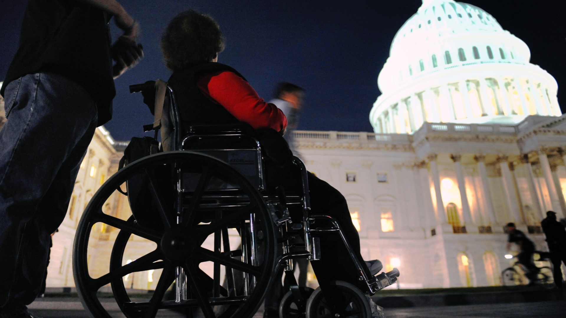 A woman in a wheelchair on the grounds of the US Capitol in Washington