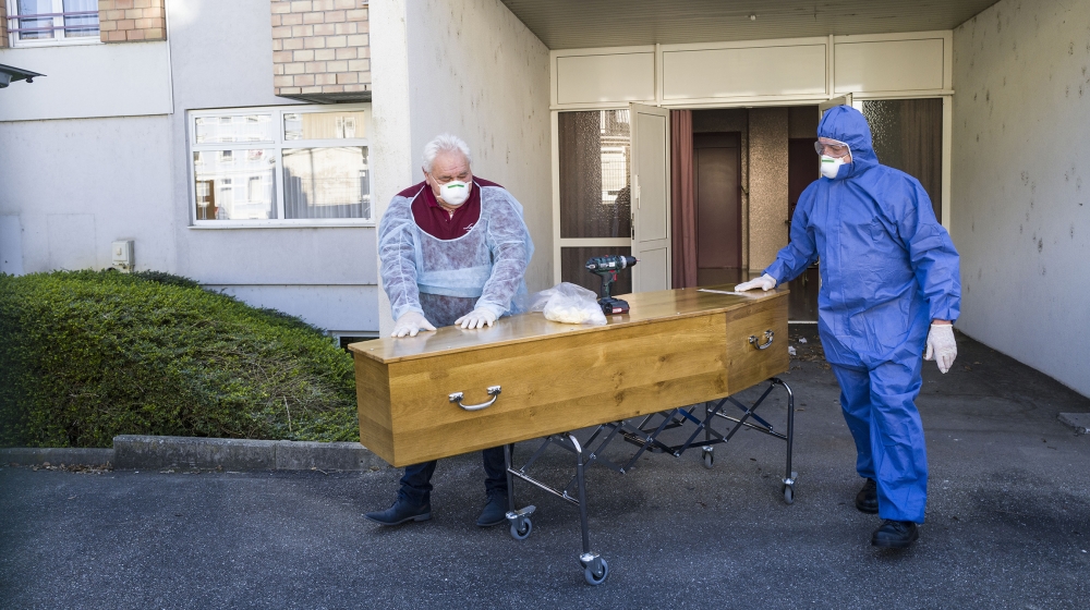 Employees of the Lantz funeral company, wearing protections, pull the coffin of a victim of the COVID-19 of an EHPAD (Housing Establishment for Dependant Elderly People), in Mulhouse, eastern France,