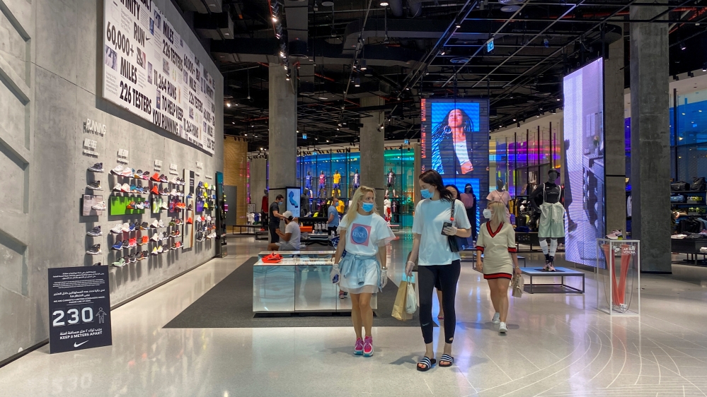People wearing protective face masks and gloves shop at Dubai mall after the UAE government eased a curfew and allowed stores to open, following the outbreak of the coronavirus disease in Dubai