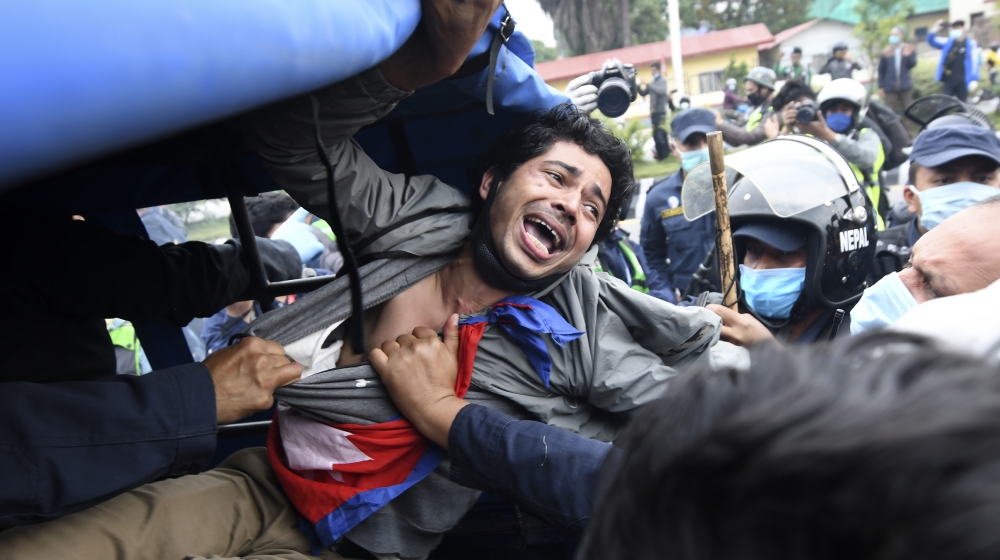 A demonstrator shouts slogans after he was detained by the police during a protest against India''s newly inaugurated link road to the Chinese border, in Kathmandu on May 11, 2020. Nepal protested Ind