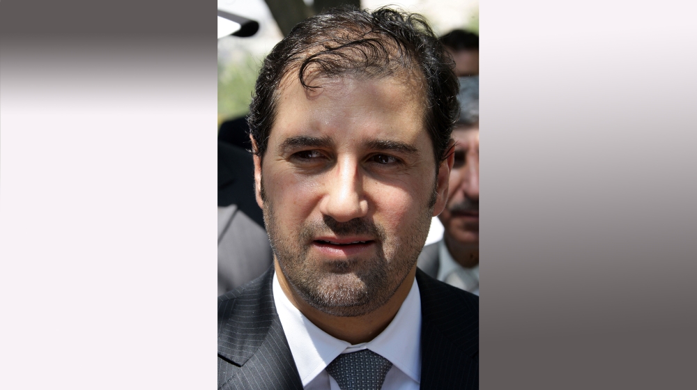 Syrian businessman Rami Makhluf attends the ceremony of raising a Syrian flag on a 107-metre pole over Damascus to celebrate President Bashar al-Assad''s 10th year in power on July 17, 2010. AFP PHOTO/