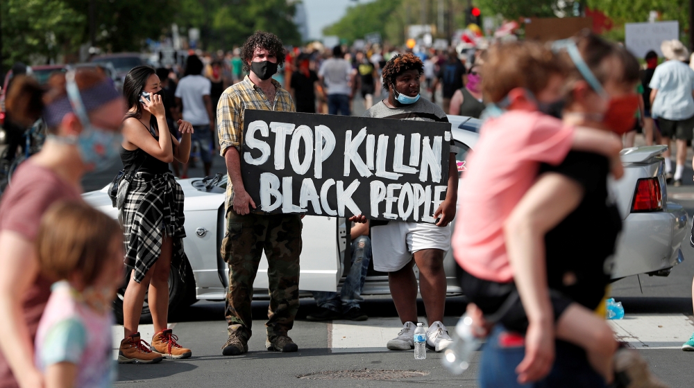 Protesters gather at the scene where George Floyd, an unarmed black man, was pinned down by a police officer kneeling on his neck before later dying in hospital in Minneapolis, Minnesota, U.S. May 26,