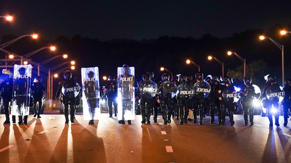 Police with riot shields advance to detain protesters for blocking traffic on a freeway during a rally against racial inequality and the police shooting death of Rayshard Brooks, in Atlanta, Georgia, on June 13, 2020