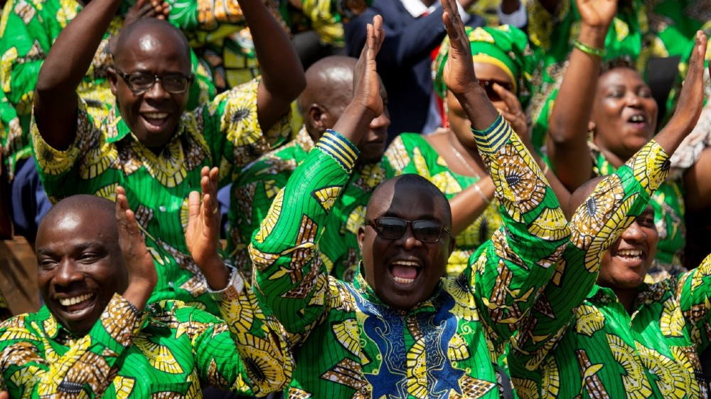 Supporters of Burundi's President elect Evariste Ndayishimiye cheer as they attend his inauguration ceremony following the sudden death of his predecessor Pierre Nkurunziza, 