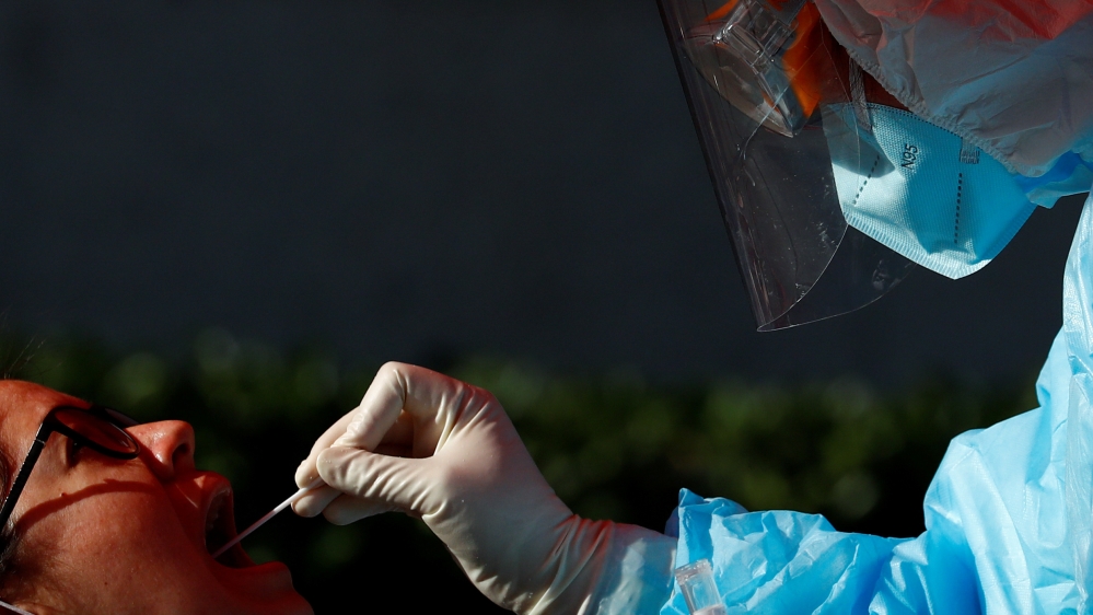 A foreign journalist gets tested for the coronavirus disease (COVID-19) before attending a news conference
